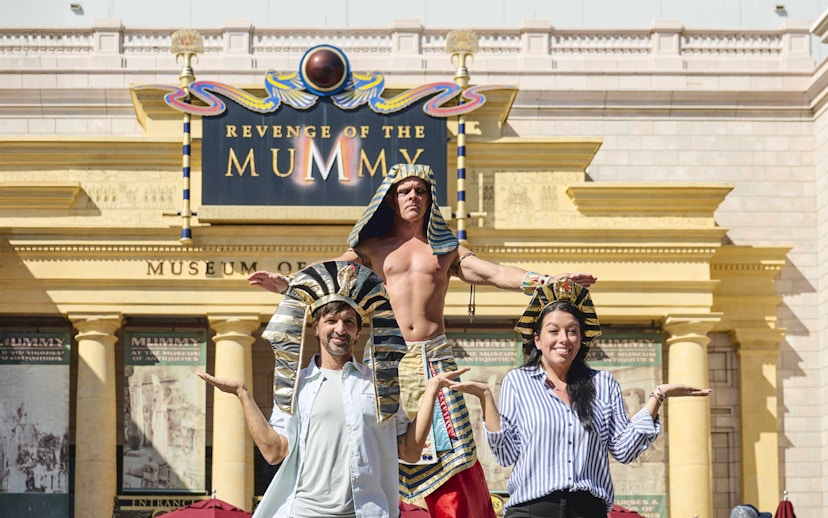 Guests posing with staff in Egyptian costumes at Revenge of the Mummy, Universal Studios Orlando.