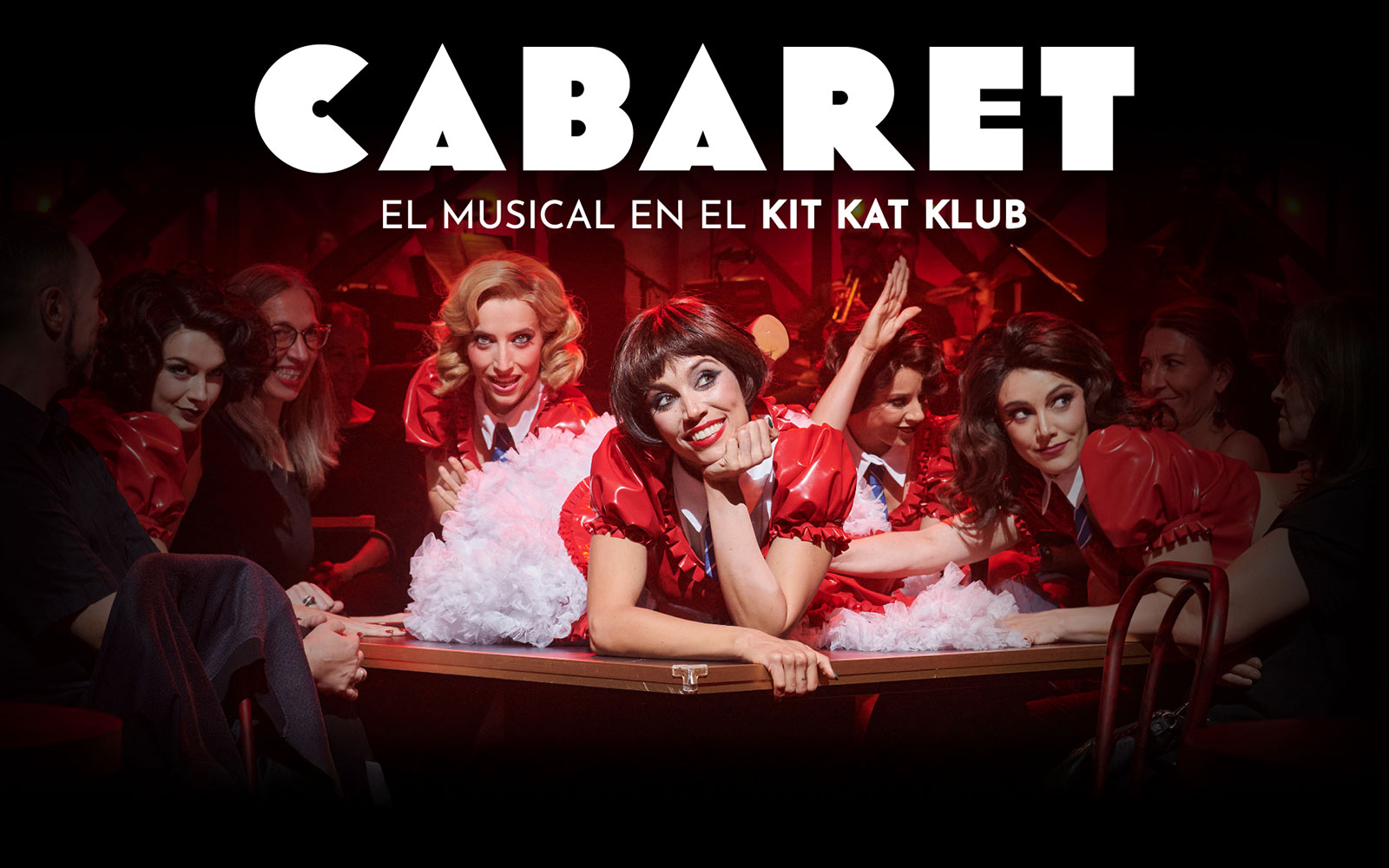 Performers in red costumes at Cabaret Madrid show, Kit Kat Klub setting.