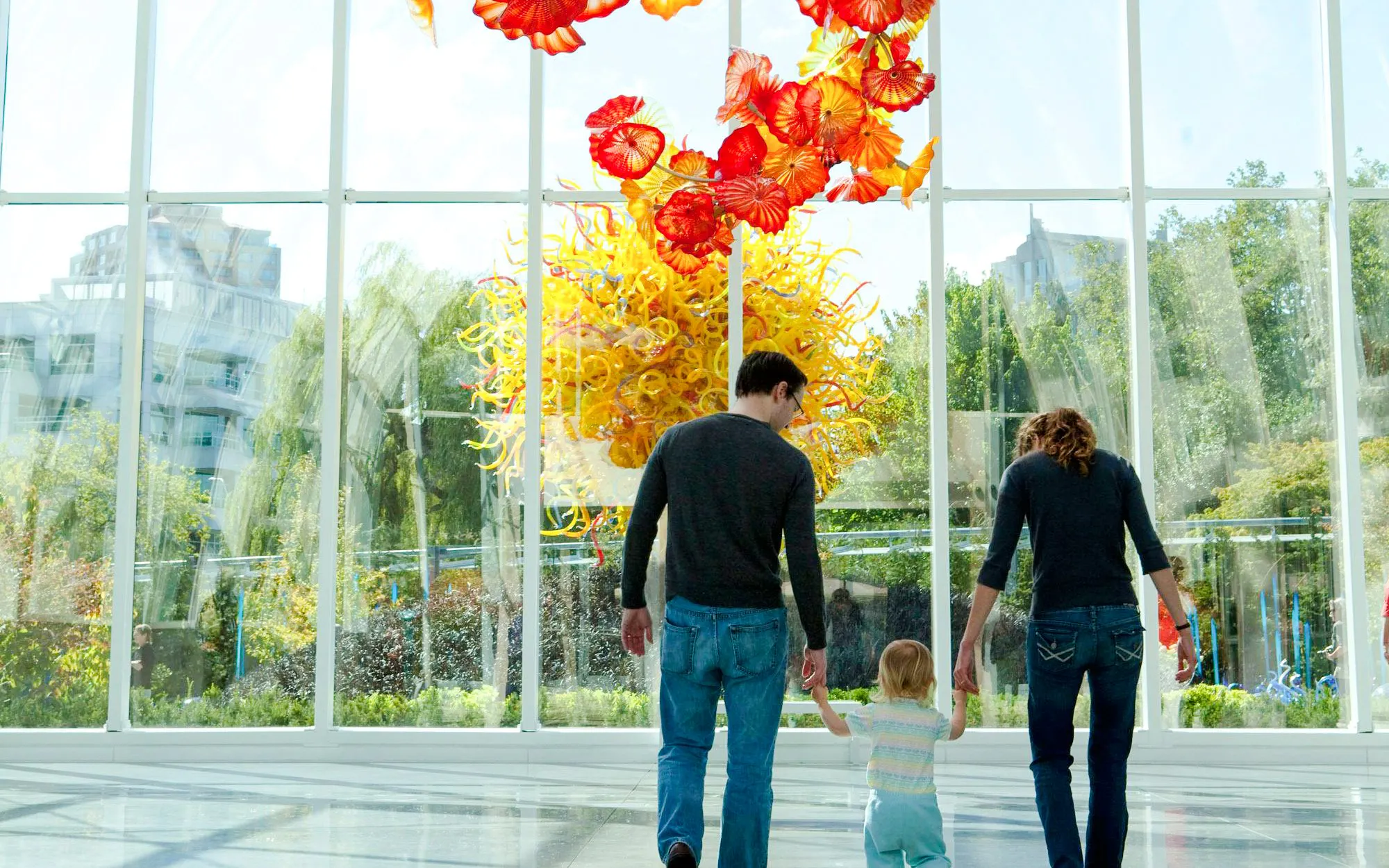 Family exploring Chihuly Garden and Glass exhibit in Seattle.