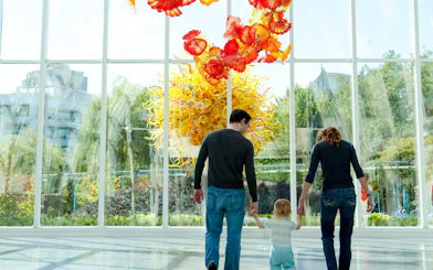 Family exploring Chihuly Garden and Glass exhibit in Seattle.