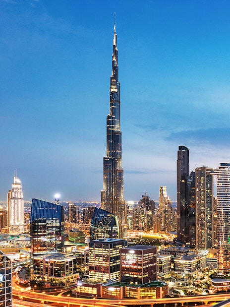 Dubai downtown skyline with Burj Khalifa and modern skyscrapers at dusk.