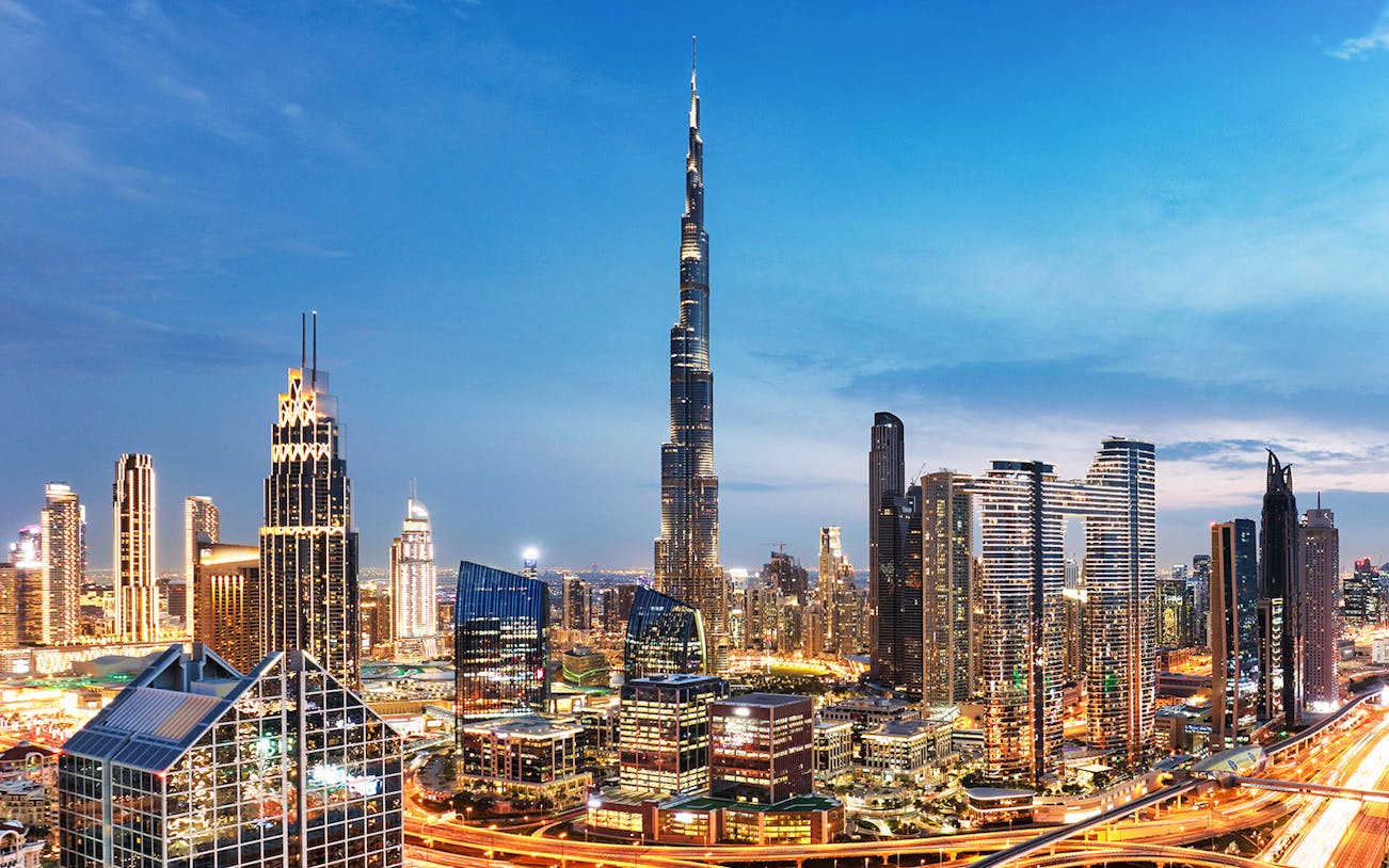 Dubai downtown skyline with Burj Khalifa and modern skyscrapers at dusk.