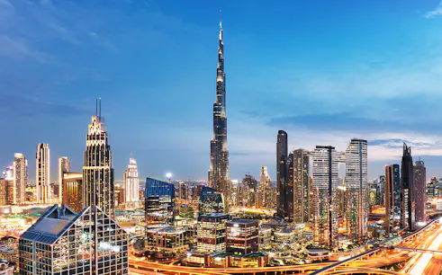 Dubai downtown skyline with Burj Khalifa and modern skyscrapers at dusk.