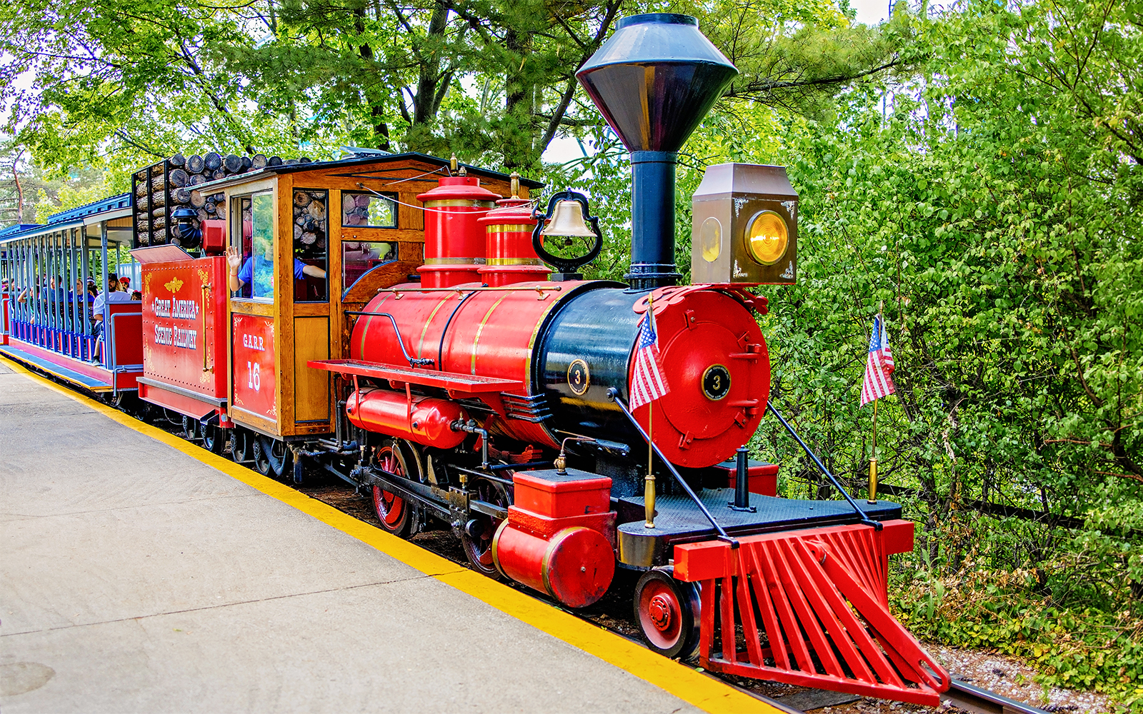 Scenic Railway train at Six Flags Great America with red locomotive and passenger cars.