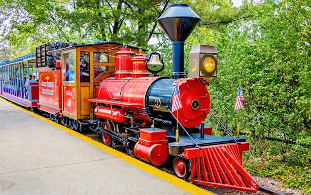 Scenic Railway train at Six Flags Great America with red locomotive and passenger cars.