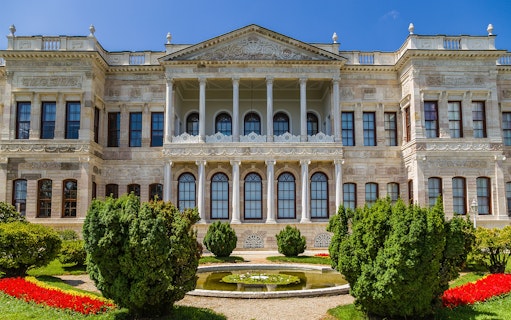 Dolmabahce Palace facade with garden and fountain, Istanbul tour.