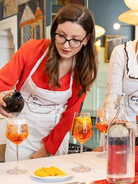 Pouring wine at a Rome cooking class.