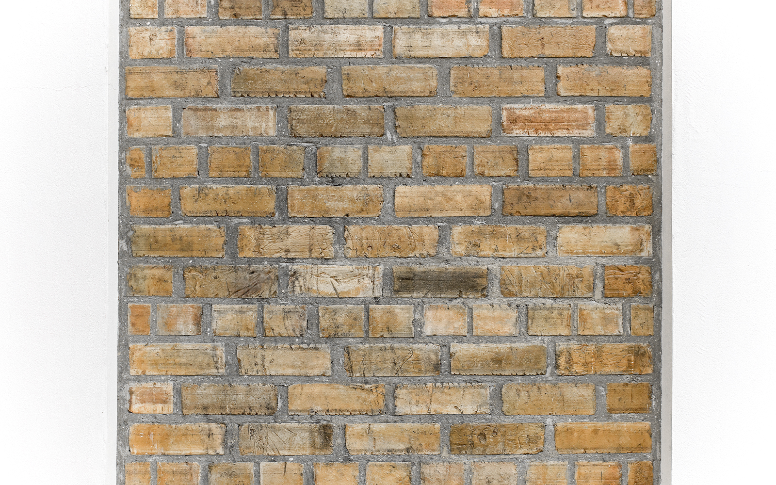 Ancient brick wall exhibit at a museum showcasing historical architecture.