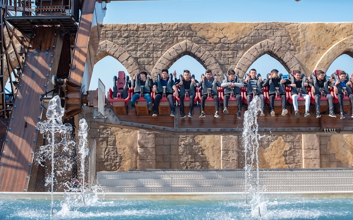 Visitors on a water ride at The Land of Legends Theme Park.