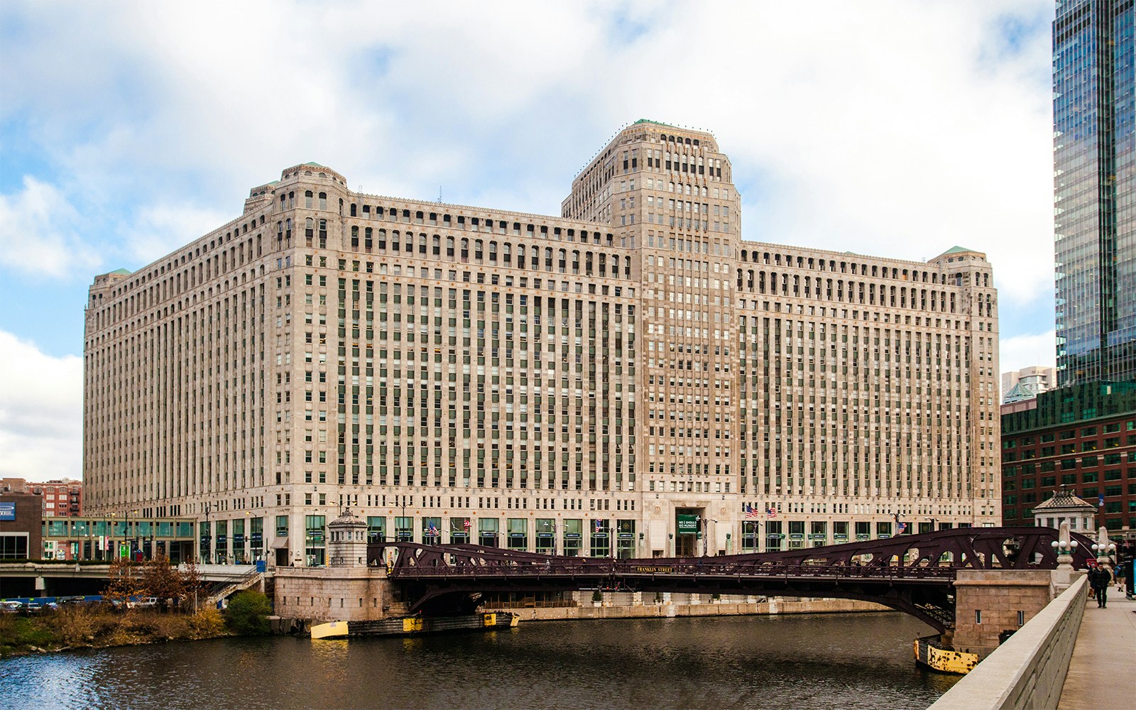 Merchandise Mart building in Chicago with river and bridge in foreground.