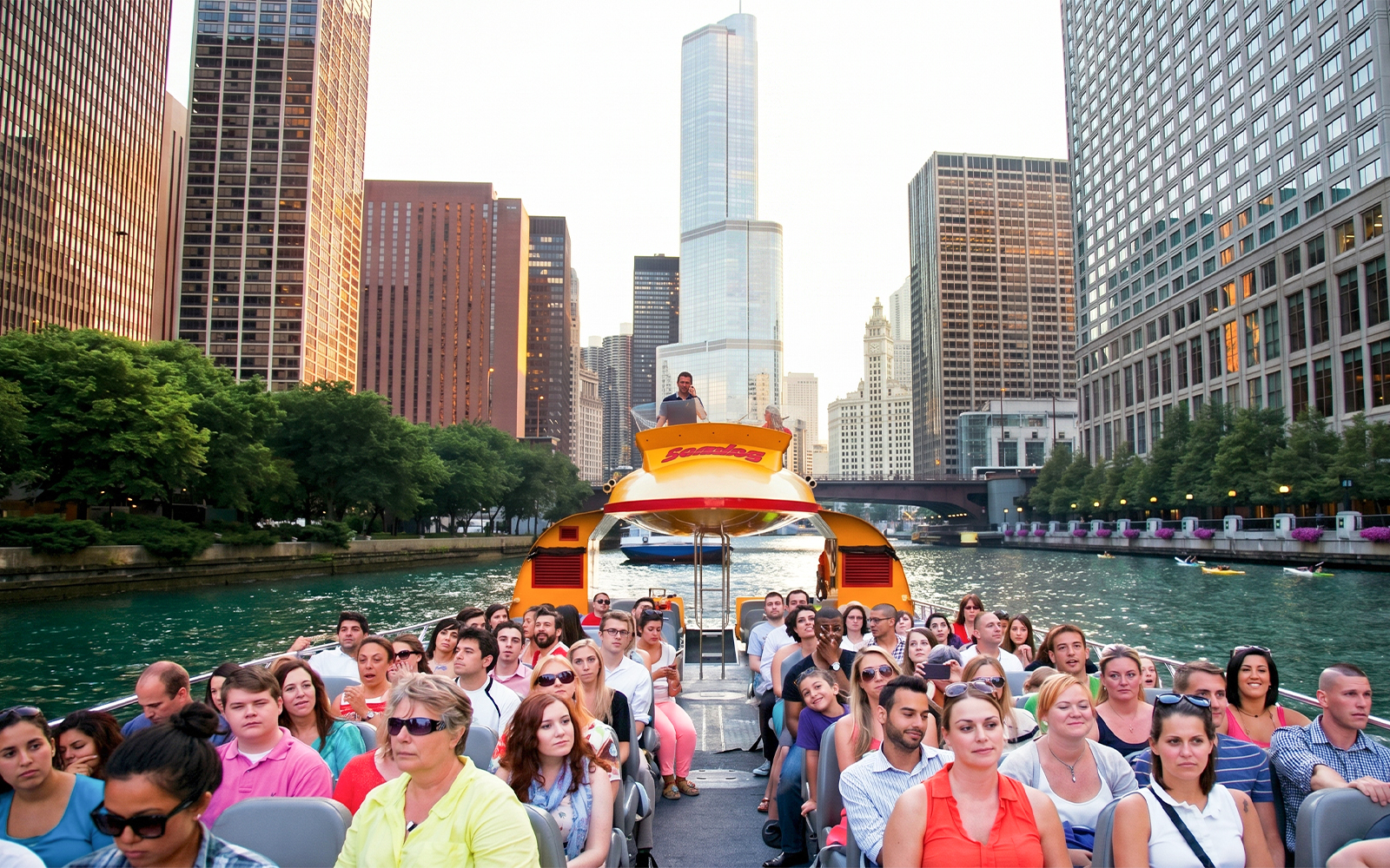 Cruise passengers on Sea Dog boat tour with Chicago skyline on Lake Michigan.