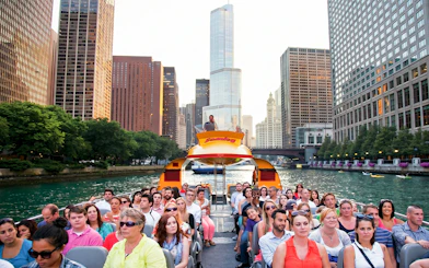 Cruise passengers on Sea Dog boat tour with Chicago skyline on Lake Michigan.