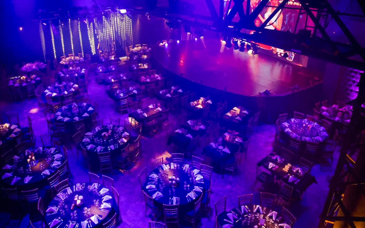 Dimly lit dining area set for Madero Tango Show in Buenos Aires.
