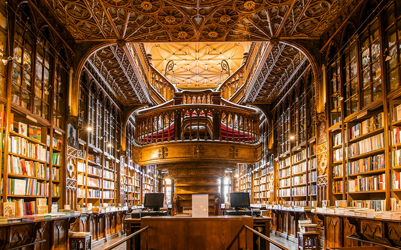 Livraria Lello bookshop exterior with ornate facade in Porto, Portugal, attracting numerous visitors.