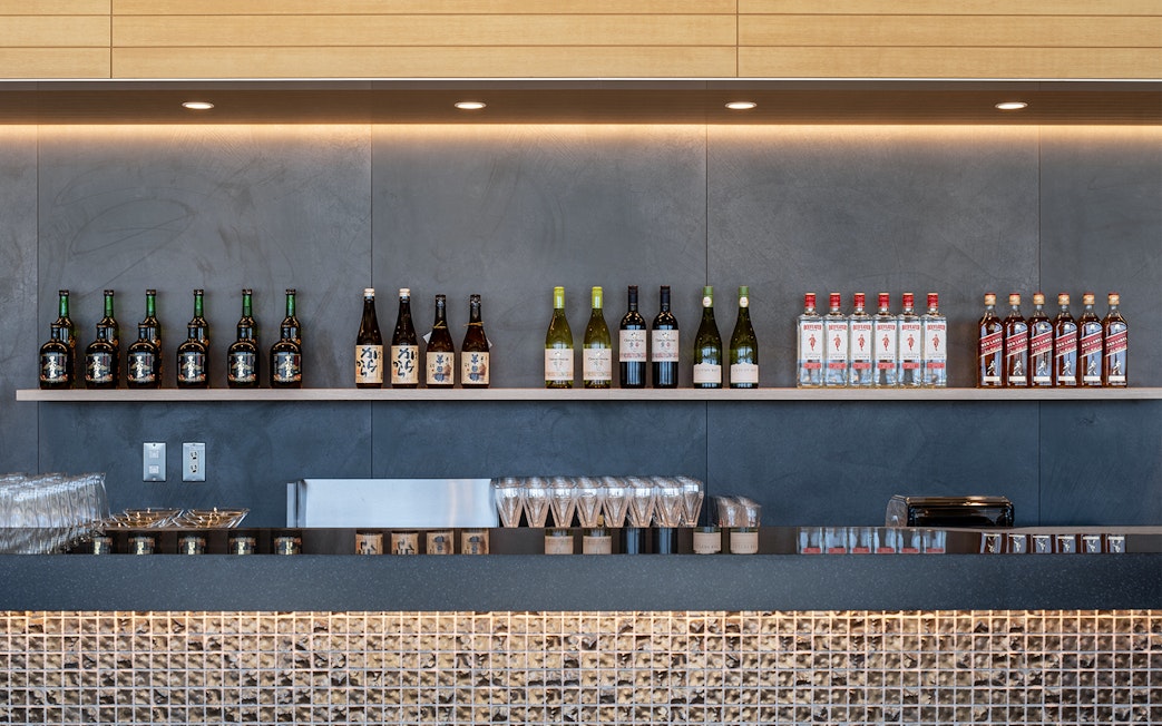 Bar counter with assorted bottles at Plaza Premium Lounge, Chubu Centrair International Airport.