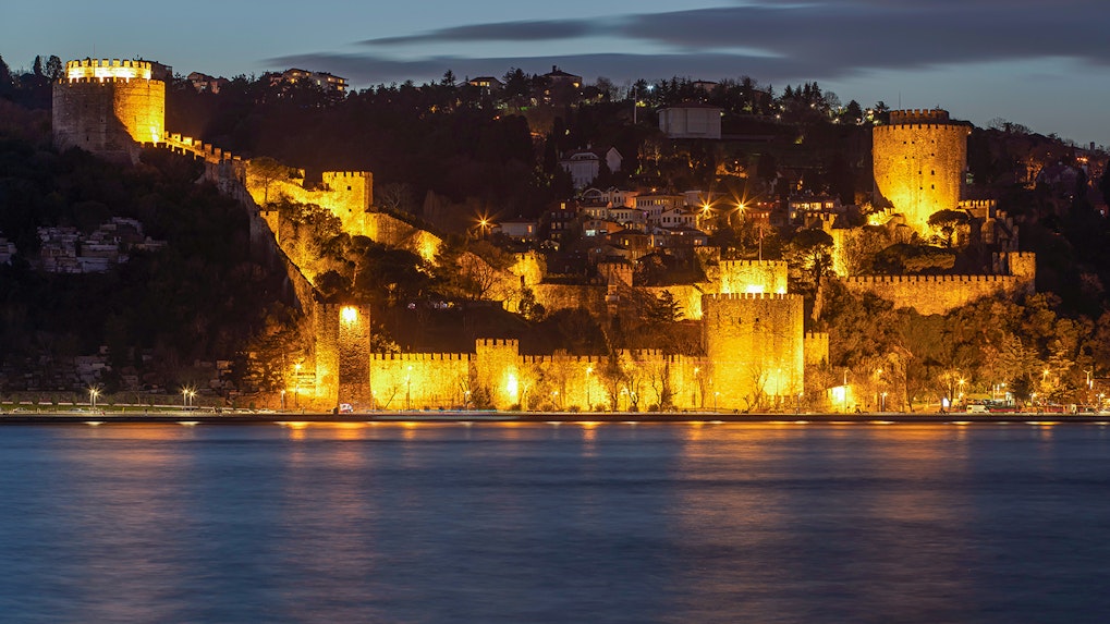 Rumeli Fortress illuminated at night, viewed from Bosphorus Dinner Cruise.