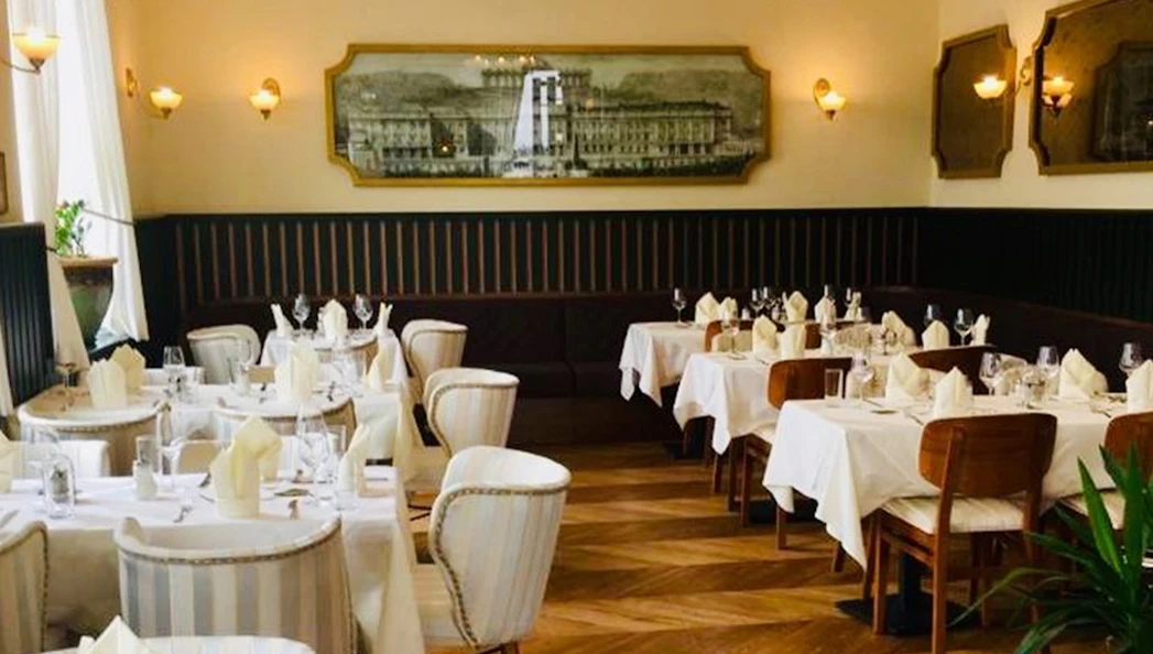 Elegant dining room set for a 3-course dinner at Schönbrunn Palace, Vienna.