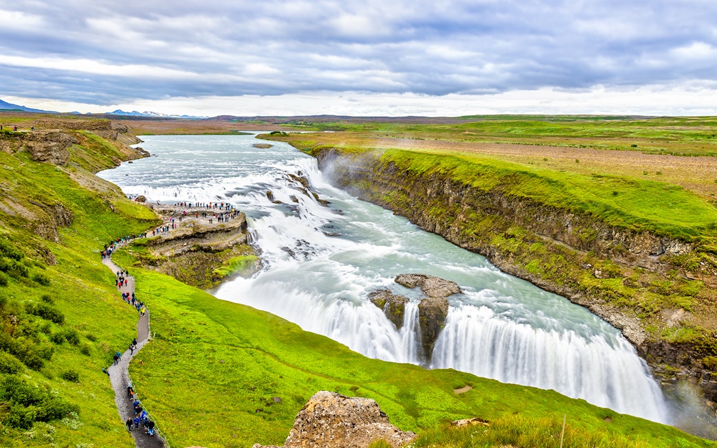 Tourists walking along a path near Gullfoss waterfall, part of Reykjavik Golden Circle Day Tour.