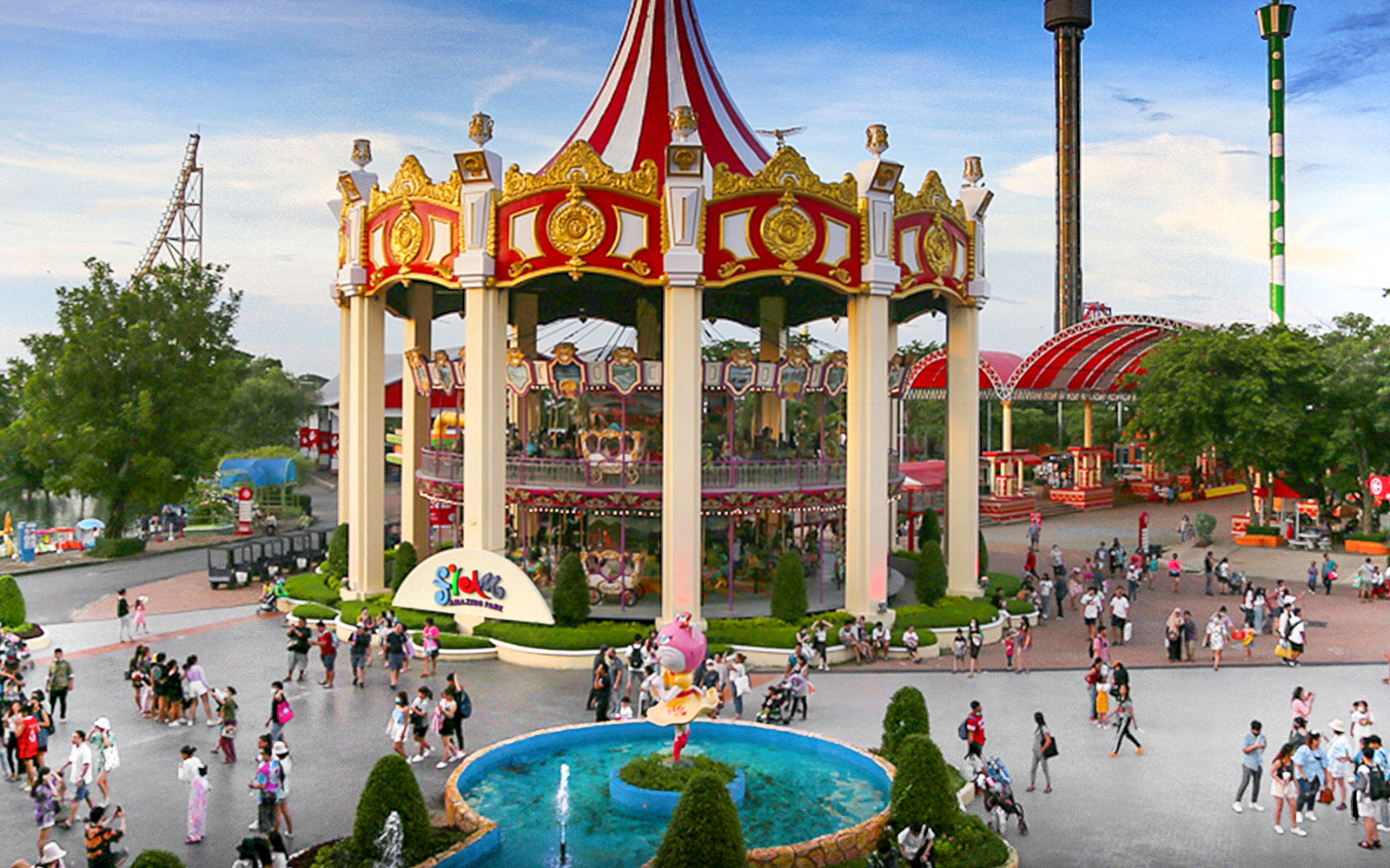 Double deck merry go round at Siam Amazing Park, Bangkok, featuring colorful horses and vibrant lights.
