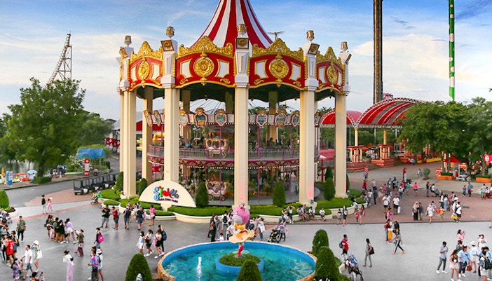 Double deck merry go round at Siam Amazing Park, Bangkok, featuring colorful horses and vibrant lights.