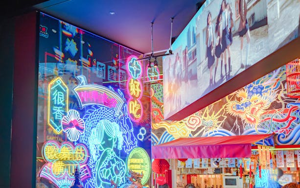 Neon lights and colorful signs in Tokyo's vibrant nightlife district.