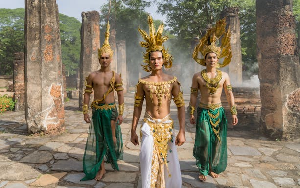 Performers in traditional Thai costumes at Siam Fantasy belief and faith show.