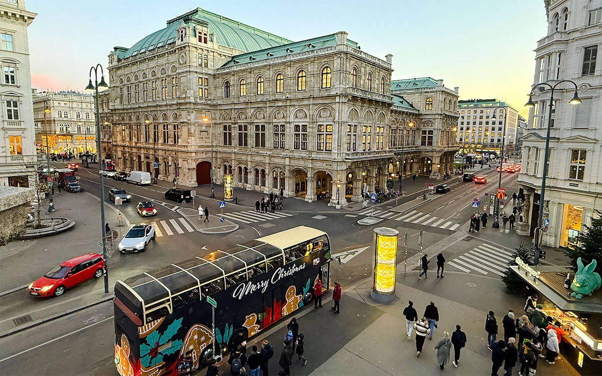 Big Bus HOHO decorated for Christmas in front of Vienna State Opera House.