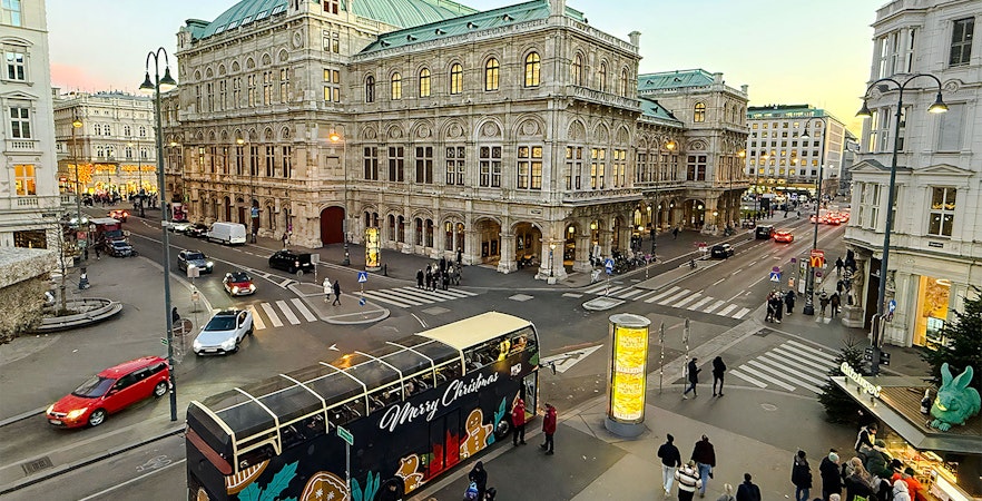 Big Bus HOHO decorated for Christmas in front of Vienna State Opera House.
