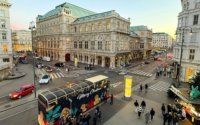 Big Bus HOHO decorated for Christmas in front of Vienna State Opera House.