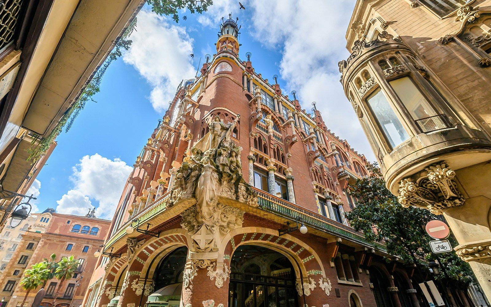 Facade of the Palau de la Música Catalana in Barcelona with ornate sculptures and colorful architecture.