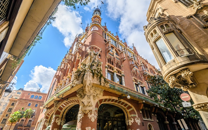Facade of the Palau de la Música Catalana in Barcelona with ornate sculptures and colorful architecture.
