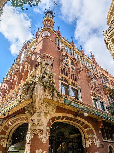 Facade of the Palau de la Música Catalana in Barcelona with ornate sculptures and colorful architecture.
