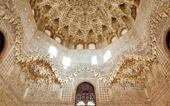 Intricate stucco ceiling and arches in the Nasrid Palace, Alhambra, Granada.