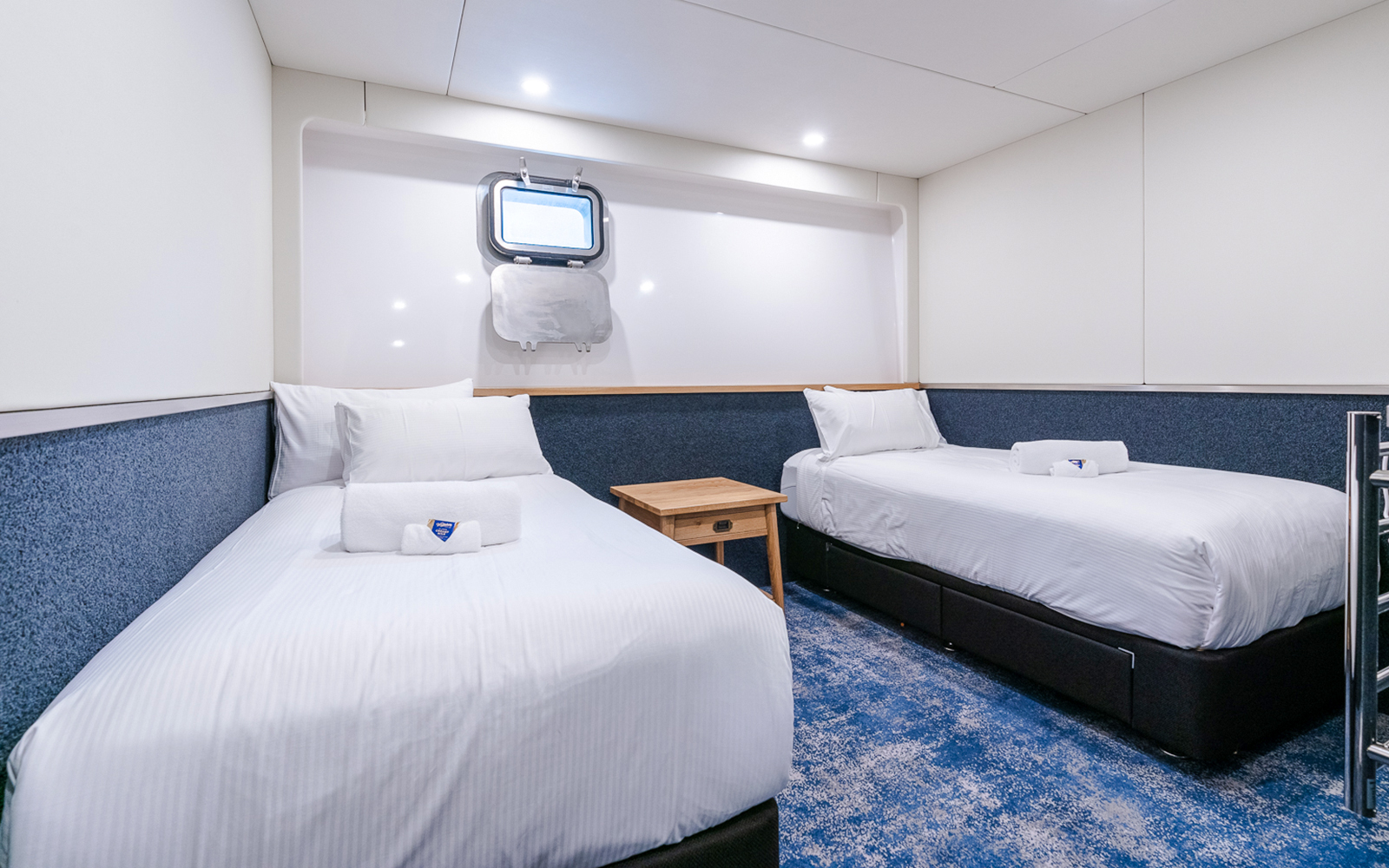 Cruise ship cabin with twin beds on Doubtful Sound cruise.