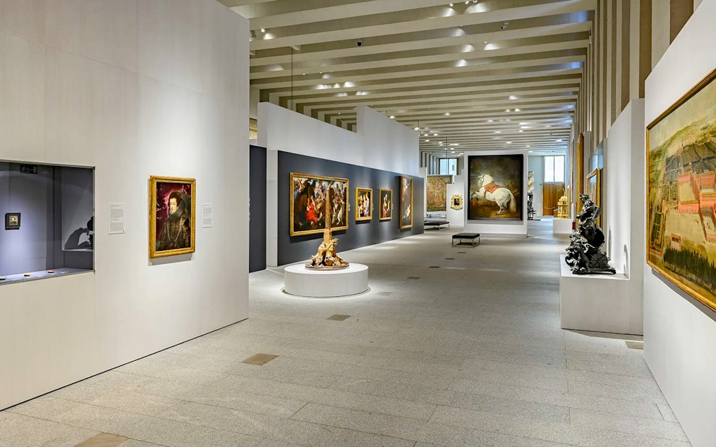 Royal Collections Gallery interior with paintings and sculptures, Madrid.