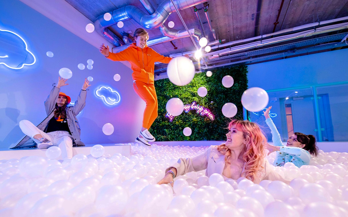 Visitors enjoying the ball pit at The Pool in Upside Down Amsterdam.