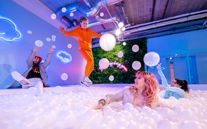 Visitors enjoying the ball pit at The Pool in Upside Down Amsterdam.