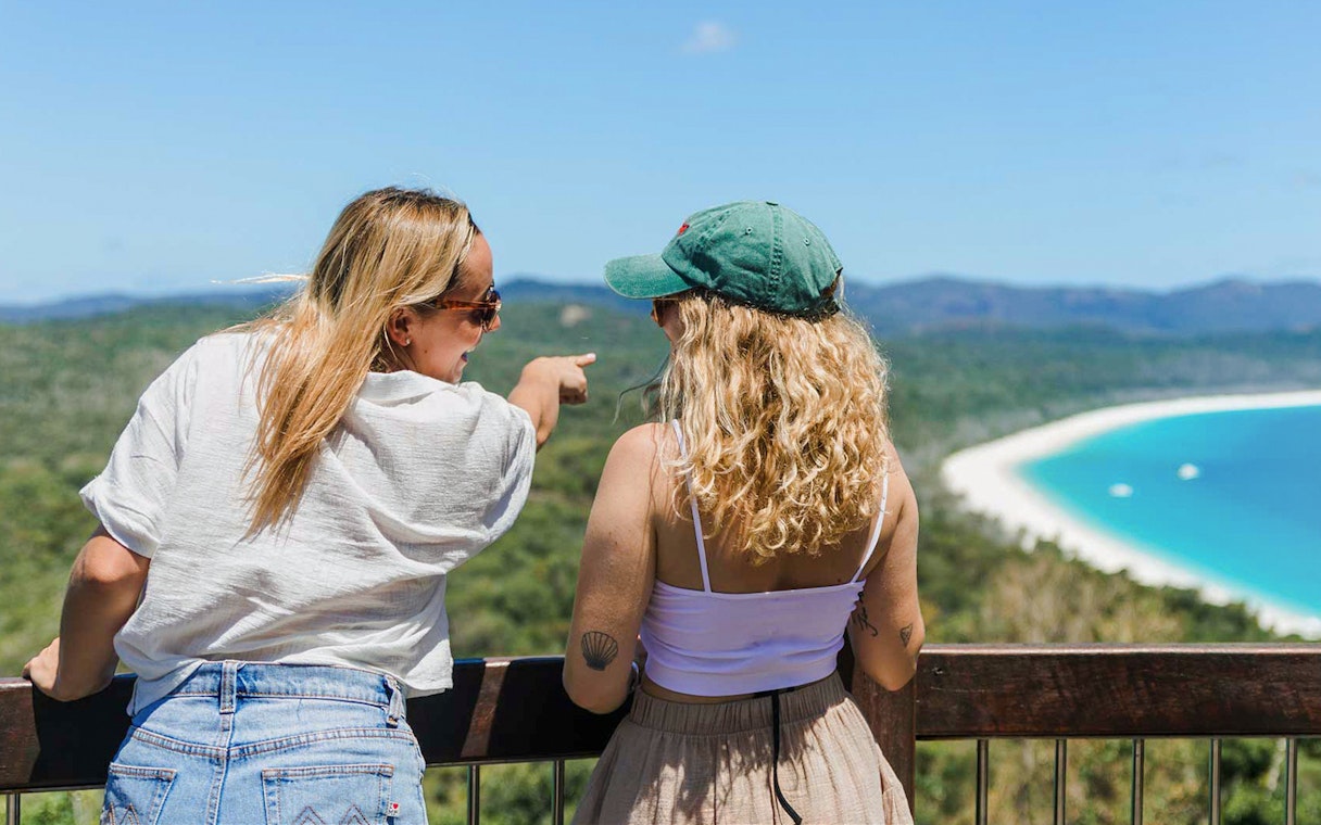 Tourists at South Whitehaven Lookout enjoying ocean and forest views.