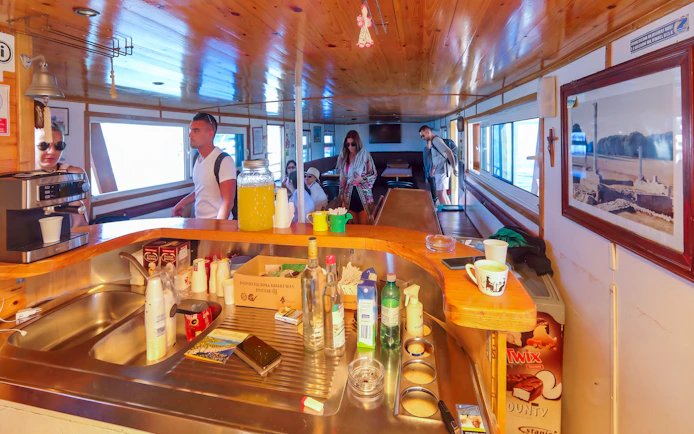 Inside view of Franzka boat with passengers near bar area, Croatia.
