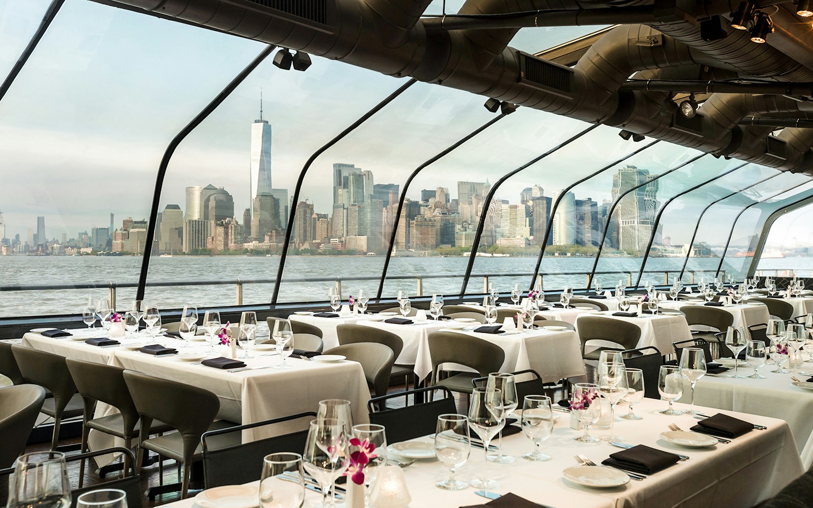 Passengers enjoying the Bateaux New York Premier brunch Cruise with a view of the city skyline