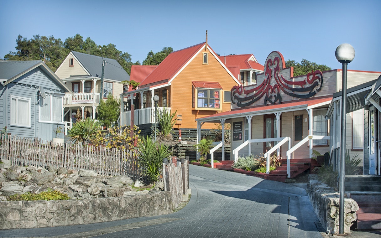 Whakarewarewa Living Maori Village traditional buildings with carved details in Rotorua, New Zealand.