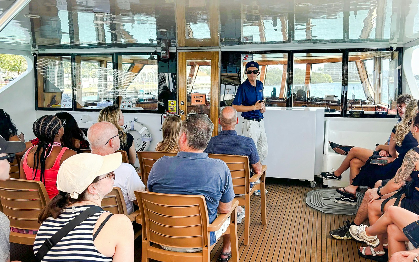 Guests enjoying a scenic cruise on the Seine River with views of the Eiffel Tower, Paris.