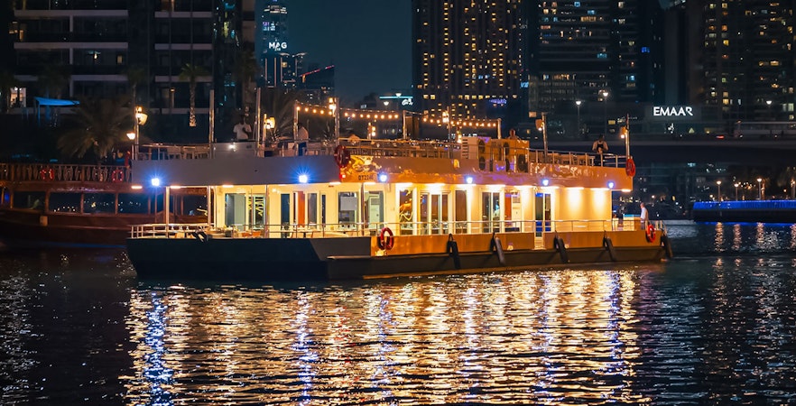 Alexandra Sea Lounge Dhow Cruise illuminated at night on Dubai Marina.