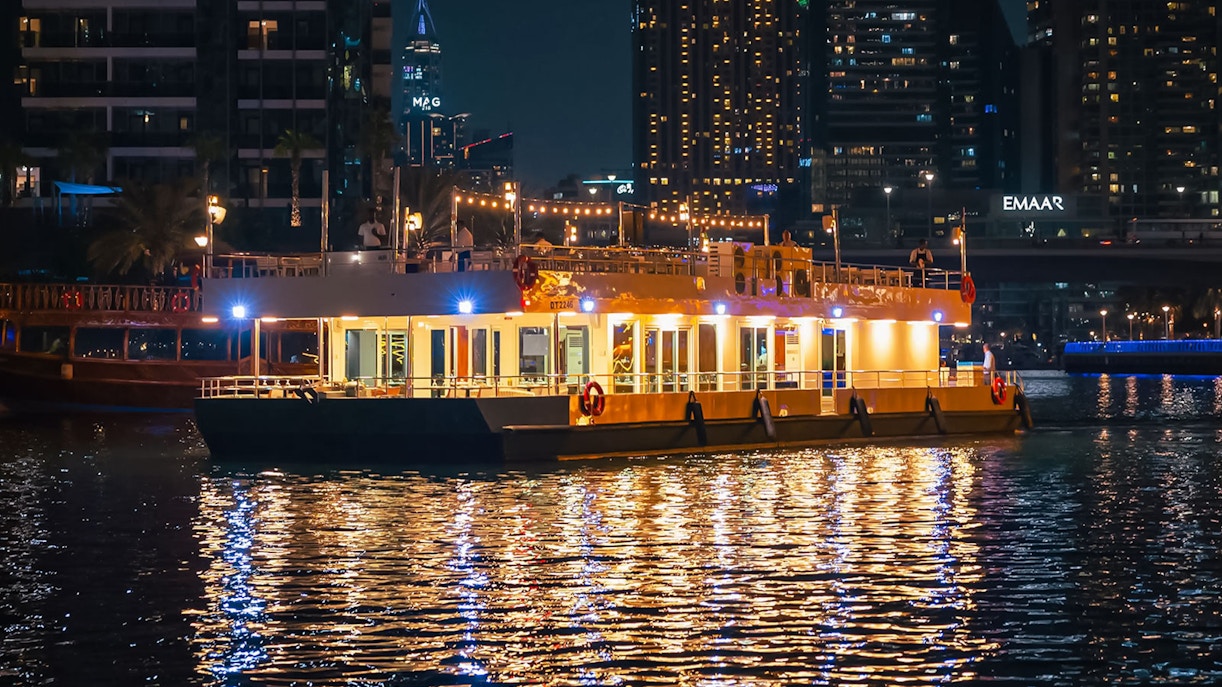 Alexandra Sea Lounge Dhow Cruise illuminated at night on Dubai Marina.