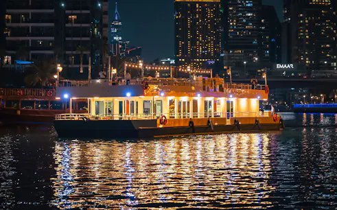 Alexandra Sea Lounge Dhow Cruise illuminated at night on Dubai Marina.