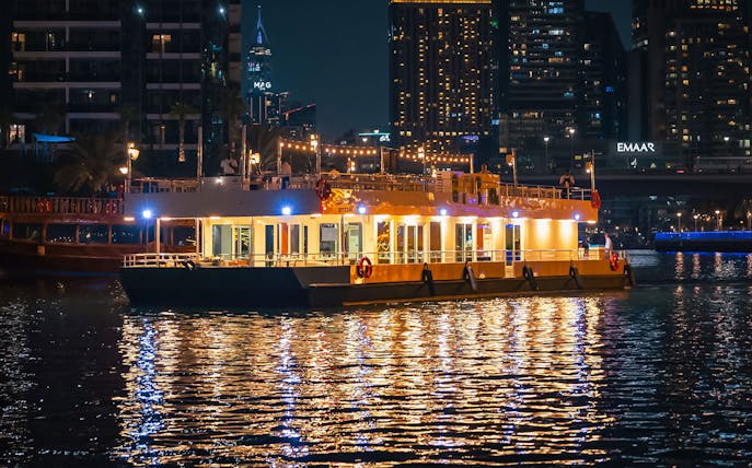 Alexandra Sea Lounge Dhow Cruise illuminated at night on Dubai Marina.