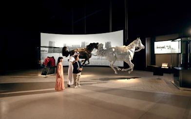 Visitors observing horse sculptures at Zayed National Museum, Abu Dhabi exhibit.