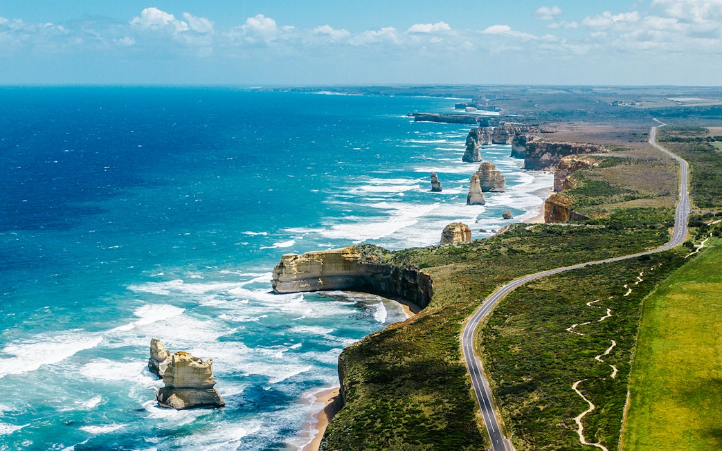 Aerial view of the Great Ocean Road with coastal cliffs and rock formations in Australia.