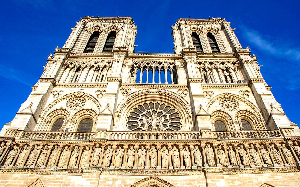 Notre-Dame Cathedral facade in Paris with detailed sculptures and rose window.