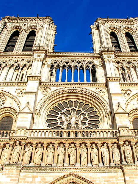 Notre-Dame Cathedral facade in Paris with detailed sculptures and rose window.